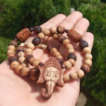Material Tulsi Bead Shape Cylindrical, Spherical Mala Length 20 Inches Deity Name Shri Ganesh Ji Carving Name Om Shri Ganesh Face Tulsi Locket Mala With Om Beads
